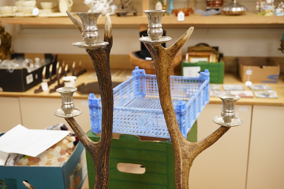 A pair of three light antler candlesticks, 67cm high